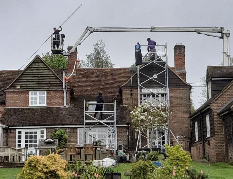 The Roof Moss Cleaners using cherry picker and scaffolding to clean roof safely and professionally in Stroud, Gloucestershire